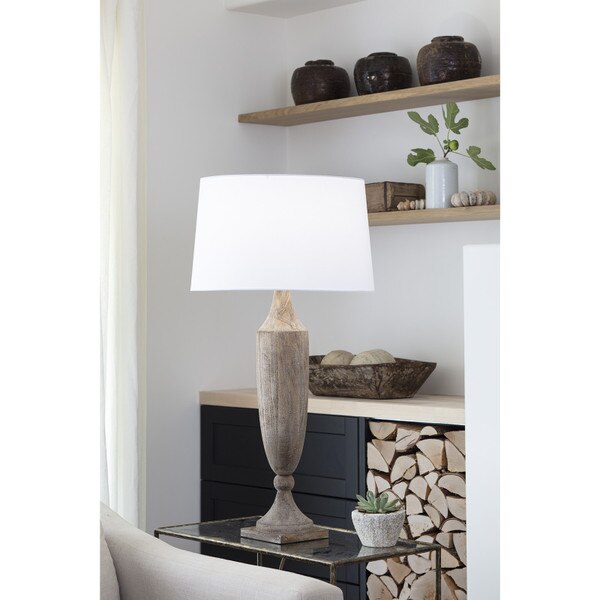 Living room with a wood table lamp and shelves
